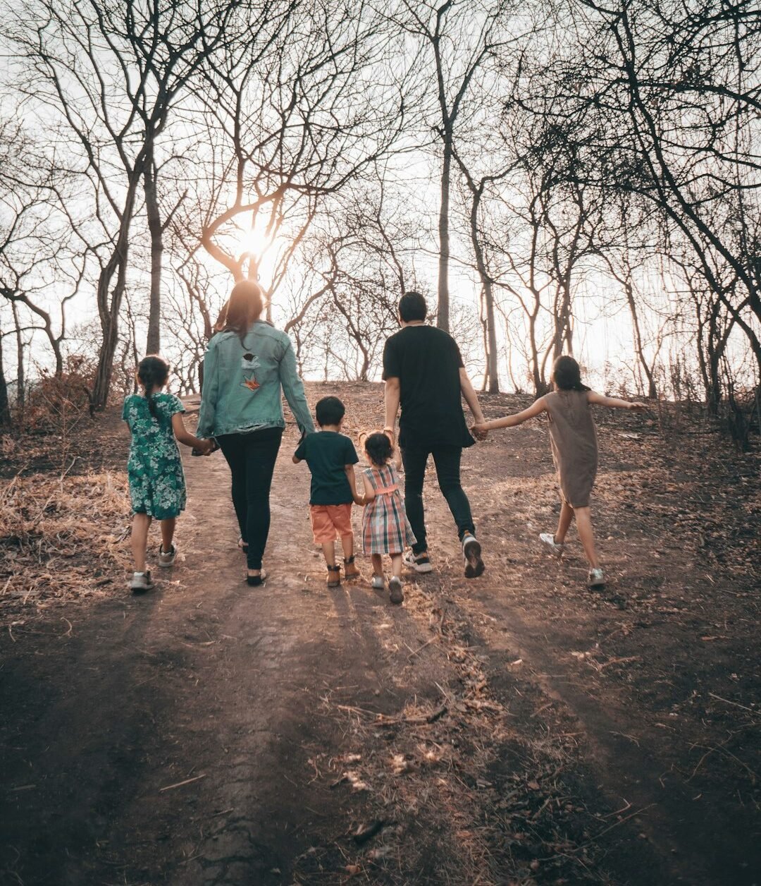 group of people standing on brown dirt road during daytime